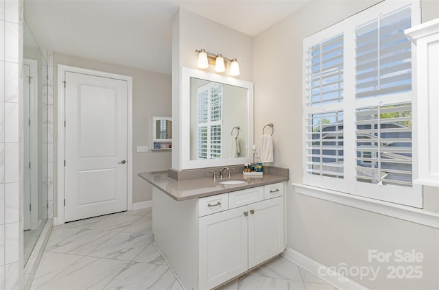 bathroom with vanity, marble finish floor, and baseboards