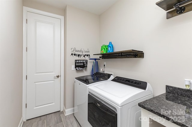 laundry room with washing machine and clothes dryer, laundry area, and baseboards