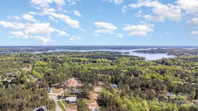 aerial view with a forest view and a water view
