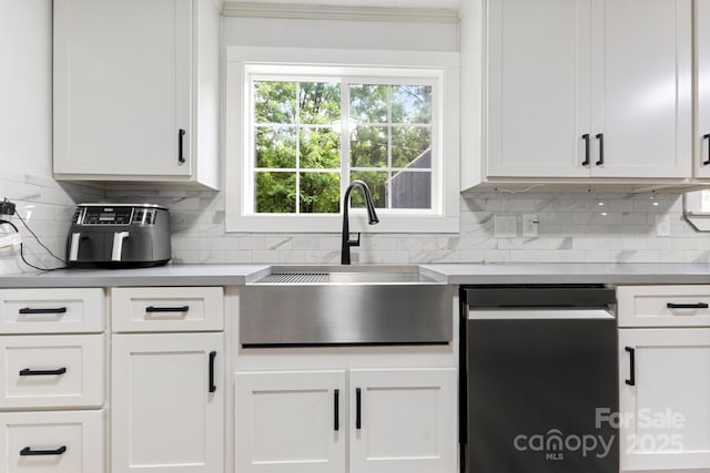 814 Columbia Dr, Chester, SC 29706 - kitchen with dishwasher, a sink, backsplash, light countertops, and white cabinetry