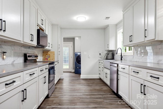 814 Columbia Dr, Chester, SC 29706 - kitchen featuring stainless steel appliances, a sink, dark wood-style floors, white cabinets, and tasteful backsplash