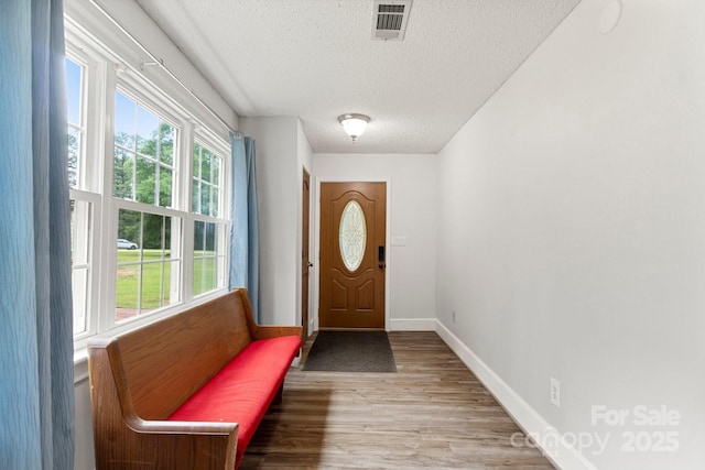 814 Columbia Dr, Chester, SC 29706 - doorway to outside with a textured ceiling, wood finished floors, and baseboards