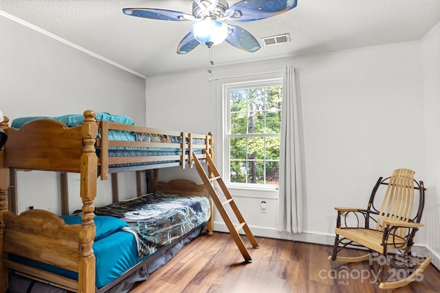 814 Columbia Dr, Chester, SC 29706 - bedroom with wood finished floors, crown molding, a textured ceiling, baseboards, and ceiling fan