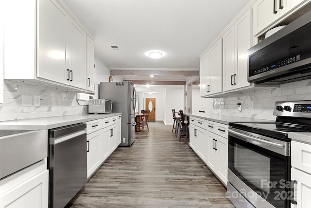 814 Columbia Dr, Chester, SC 29706 - kitchen with stainless steel appliances, light countertops, tasteful backsplash, and white cabinets