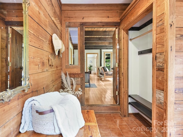 interior space featuring tile patterned floors and wooden walls