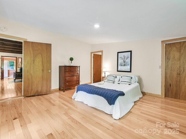bedroom featuring baseboards and wood finished floors