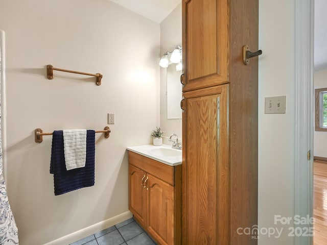 bathroom featuring vanity, baseboards, and tile patterned floors