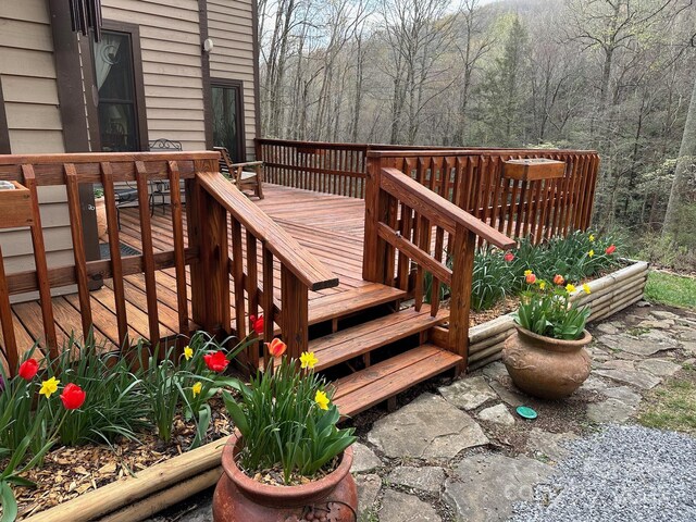 wooden deck featuring a view of trees