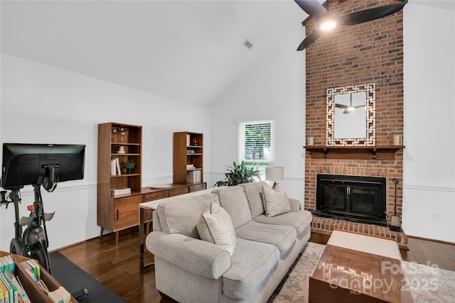 living room featuring visible vents, a brick fireplace, high vaulted ceiling, and dark wood finished floors