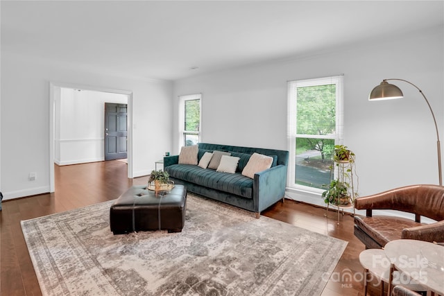 living area with wood finished floors and baseboards
