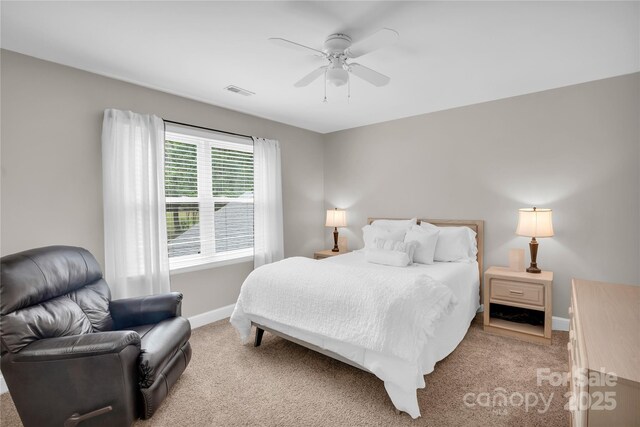 bedroom featuring visible vents, baseboards, and light carpet
