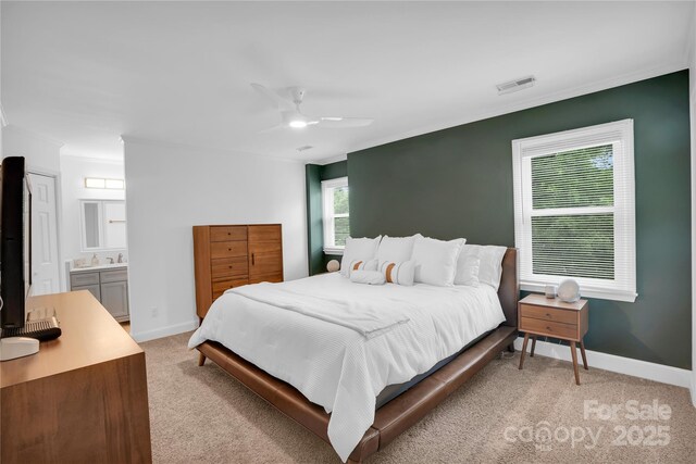 bedroom featuring visible vents, ornamental molding, ceiling fan, and light colored carpet