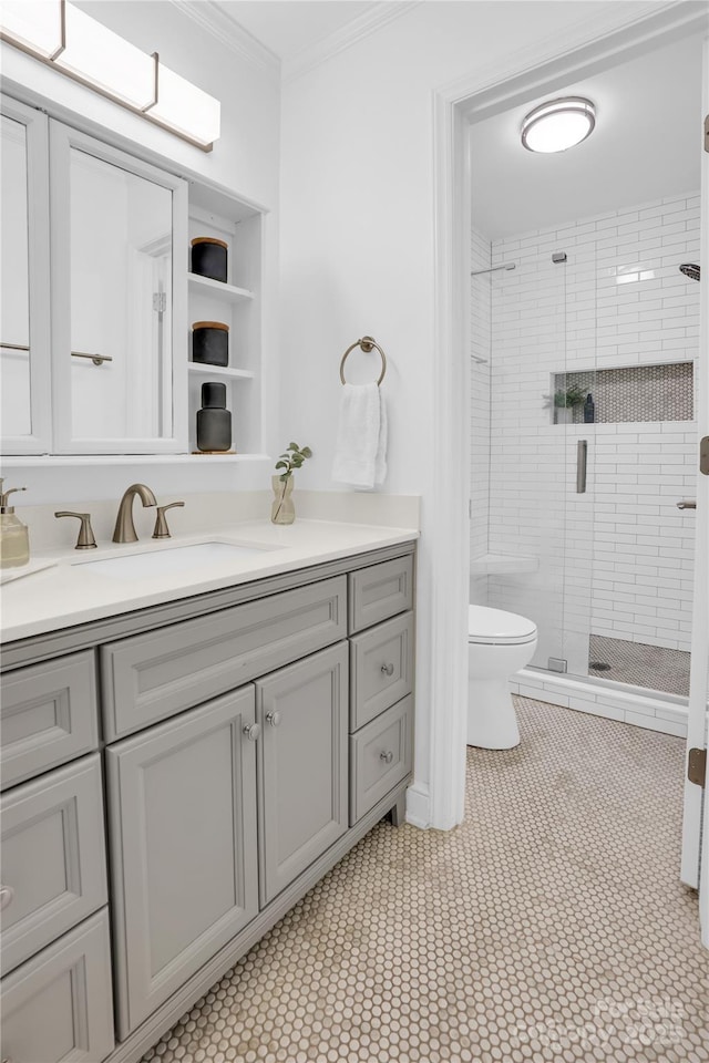 bathroom with toilet, crown molding, vanity, and a stall shower