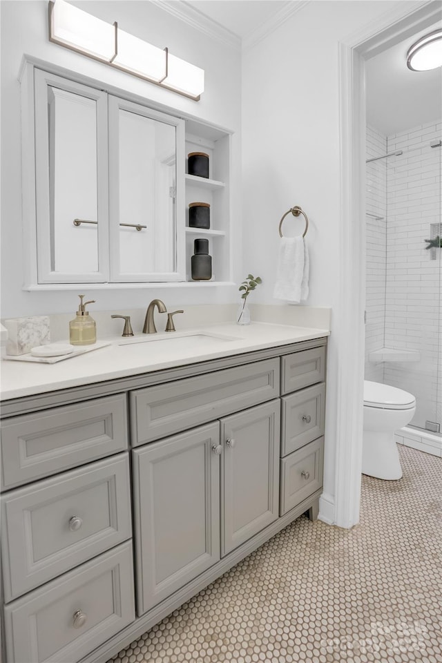 bathroom with toilet, vanity, a shower stall, and crown molding