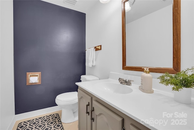 bathroom with visible vents, baseboards, toilet, tile patterned floors, and vanity