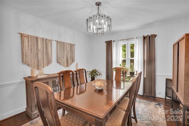 dining space featuring an inviting chandelier, crown molding, and dark wood-type flooring