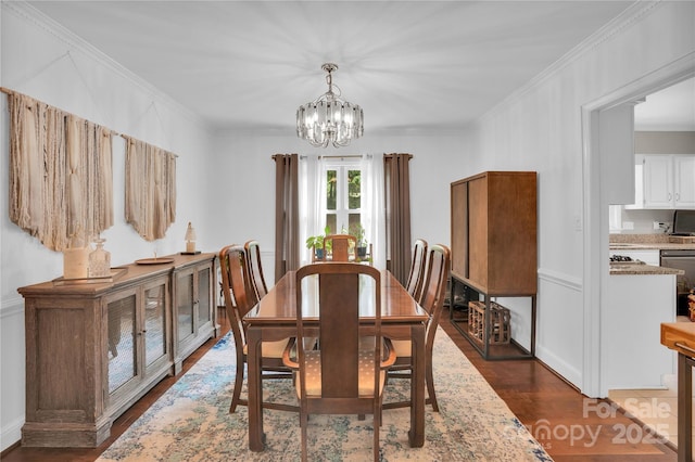 dining space with a chandelier, ornamental molding, and dark wood-type flooring