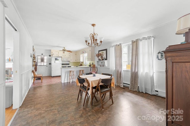 1307 Armstrong Rd, Belmont, NC 28012 - dining room featuring a chandelier, ornamental molding, healthy amount of natural light, a ceiling fan, and a baseboard radiator