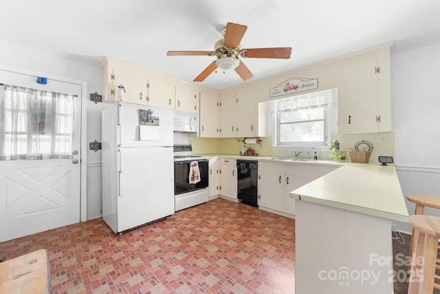 1307 Armstrong Rd, Belmont, NC 28012 - kitchen with white appliances, a peninsula, light countertops, ceiling fan, and ornamental molding