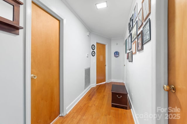 1307 Armstrong Rd, Belmont, NC 28012 - hallway featuring light wood finished floors, crown molding, and baseboards