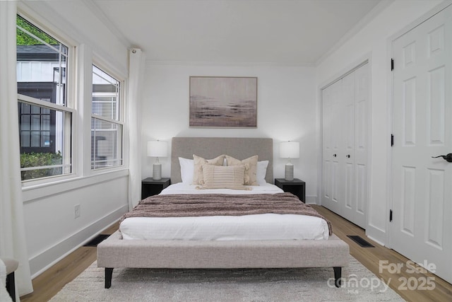 2138 Revolution Park Dr, Charlotte, NC 28208 - bedroom featuring wood finished floors and crown molding