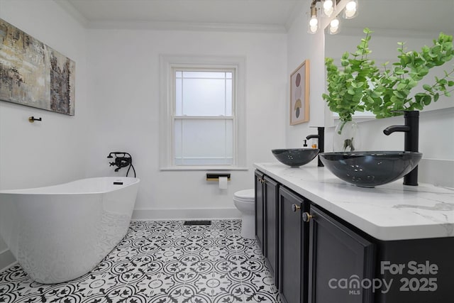 2138 Revolution Park Dr, Charlotte, NC 28208 - full bath featuring a freestanding bath, double vanity, and crown molding