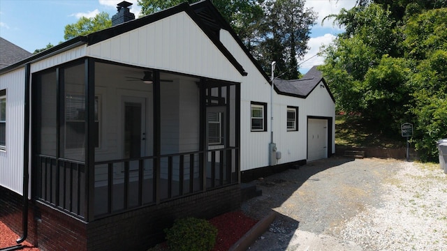 2138 Revolution Park Dr, Charlotte, NC 28208 - view of front of house with a shingled roof, an attached garage, a sunroom, gravel driveway, and a chimney