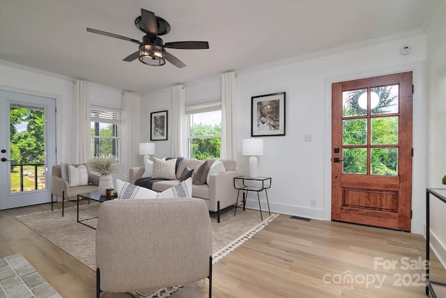 2138 Revolution Park Dr, Charlotte, NC 28208 - living room with light wood-style floors, a ceiling fan, and ornamental molding