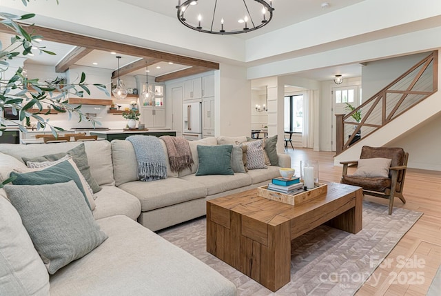living room with recessed lighting, a notable chandelier, and stairway