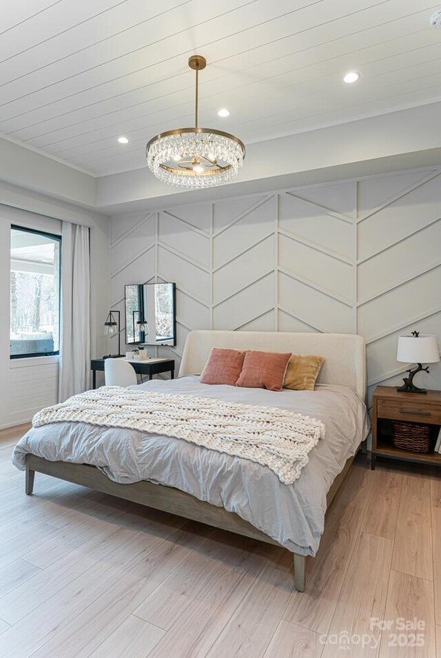 bedroom featuring crown molding, a notable chandelier, light wood-style floors, and recessed lighting