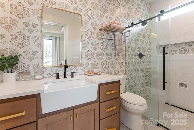 bathroom with wallpapered walls, a shower stall, and toilet