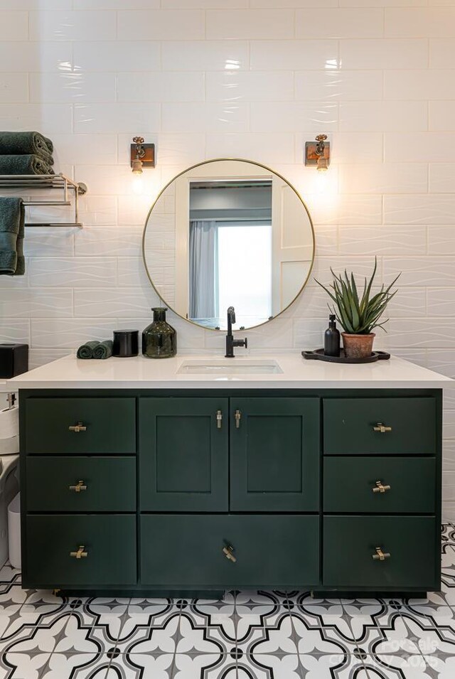 bathroom featuring tasteful backsplash, vanity, and tile walls