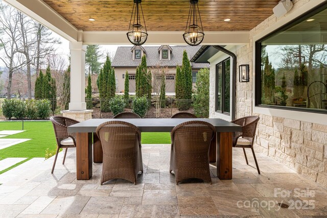 view of patio featuring fence and outdoor dining area