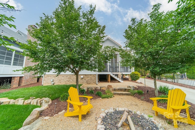 365 Delburg St, Davidson, NC 28036 - view of yard featuring stairway, fence, and a sunroom