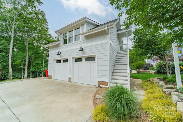 365 Delburg St, Davidson, NC 28036 - view of side of home with a garage, stairway, and driveway