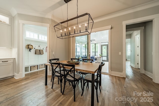 365 Delburg St, Davidson, NC 28036 - dining room featuring ornamental molding, light wood-style floors, a chandelier, and baseboards