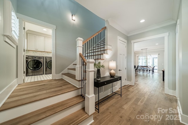 365 Delburg St, Davidson, NC 28036 - stairs with washer and clothes dryer, wood finished floors, crown molding, a chandelier, and baseboards