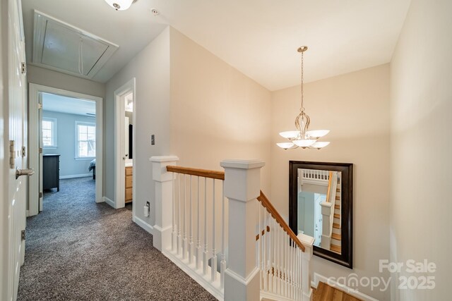 984 Park Slope Dr, Charlotte, NC 28209 - hall featuring attic access, an upstairs landing, carpet, a chandelier, and baseboards
