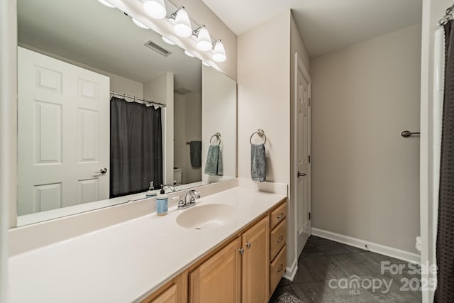 984 Park Slope Dr, Charlotte, NC 28209 - full bath with toilet, vanity, baseboards, and a shower with shower curtain