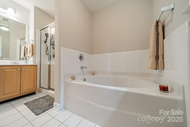 984 Park Slope Dr, Charlotte, NC 28209 - full bathroom featuring a garden tub, vanity, a stall shower, and tile patterned flooring