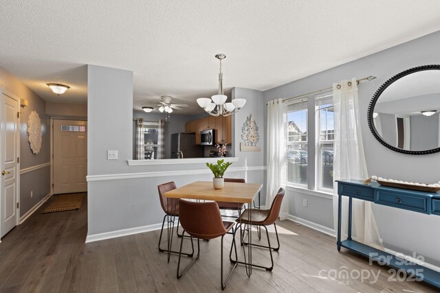 1201 Deermouse Way, Hendersonville, NC 28792 - dining room featuring wood finished floors, a textured ceiling, baseboards, and a notable chandelier