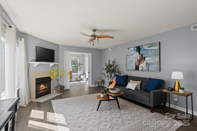 1201 Deermouse Way, Hendersonville, NC 28792 - living room featuring a ceiling fan, wood finished floors, and a tiled fireplace