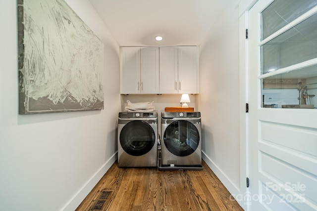 laundry room featuring cabinet space, independent washer and dryer, baseboards, and dark wood-style flooring