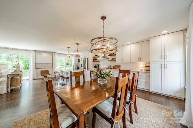 dining room featuring recessed lighting, dark wood finished floors, and a notable chandelier