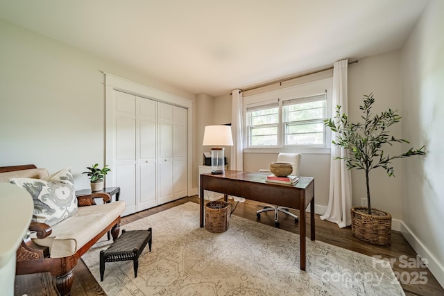 home office with baseboards and wood finished floors
