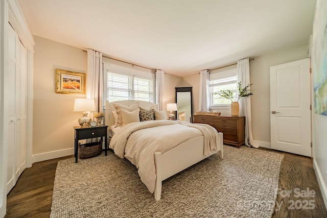 bedroom with baseboards and dark wood-style floors