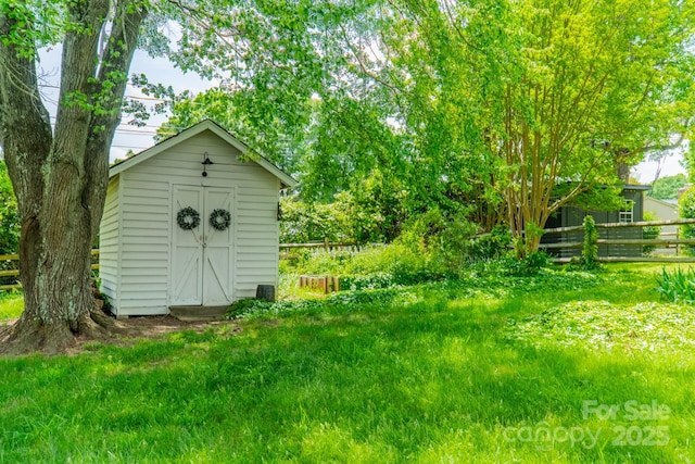 view of shed featuring fence