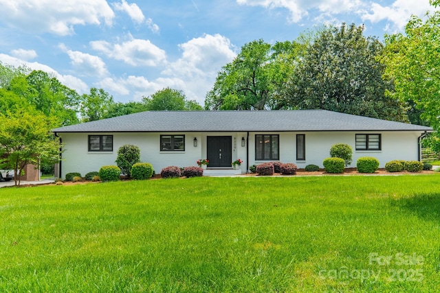 ranch-style house with a shingled roof and a front lawn