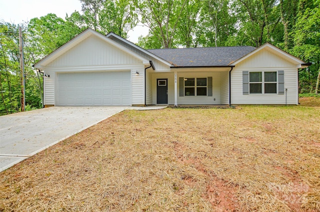 ranch-style house featuring covered porch, a front yard, roof with shingles, a garage, and concrete driveway