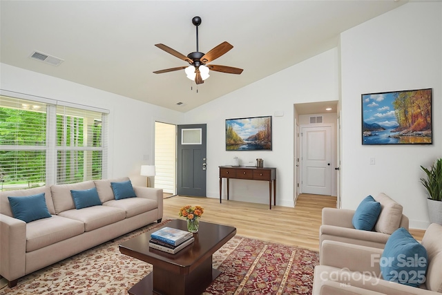living room with ceiling fan, visible vents, baseboards, and light wood-style floors